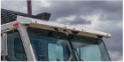 Truck cab with exterior sun visor